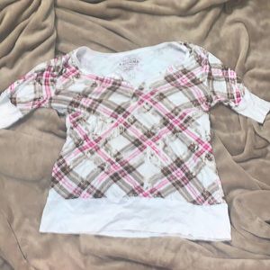 Plaid brown and magenta top with buttons midway down the center.